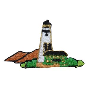 May include: An embroidered patch of a white lighthouse with a black roof and a brown rocky island. The lighthouse is on a green island with gold trim.