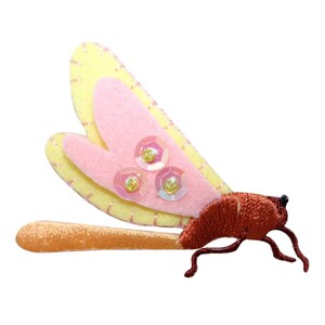 May include: A pink and yellow felt dragonfly with iridescent sequins on its wings and a brown felt body.