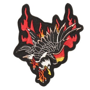 May include: Black and white embroidered patch of a bird with wings spread, flying through flames. The flames are red and orange.