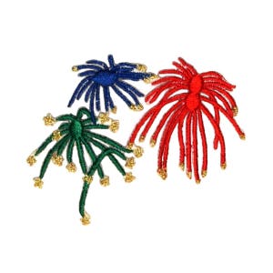 May include: Three embroidered firework designs in red, green, and blue with gold accents.