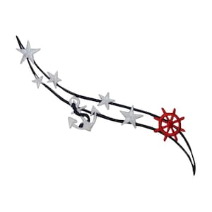 May include: A black and white embroidered design of a nautical theme with stars, an anchor, and a red ship's wheel.