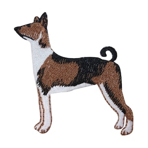 May include: Embroidered patch of a brown and black Basenji dog with white markings. The dog is standing with its tail curled up.