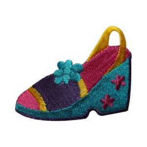 May include: An embroidered patch of a colorful shoe with a wedge heel. The shoe is pink, purple, teal, and yellow with a flower design on the side.