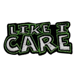 May include: Green and white embroidered patch with the text "Like I Care" in a bold, blocky font.