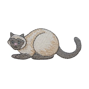 May include: A beige and gray embroidered patch of a Siamese cat lying down with its tail curled around its body.