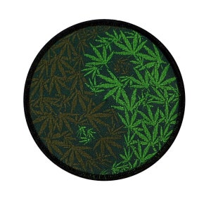 May include: A round, black-edged patch with a green and brown marijuana leaf design. The design is a yin-yang symbol with the leaves forming the two halves.