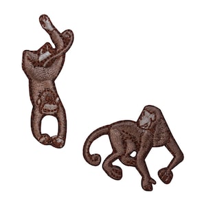 May include: Two brown embroidered monkey patches. One monkey is hanging upside down with its arms raised above its head. The other monkey is walking on all fours.