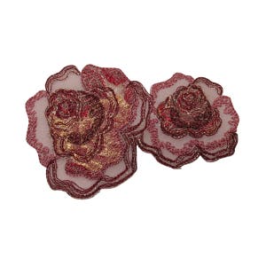 May include: Two pink and red embroidered rose appliques with gold accents.