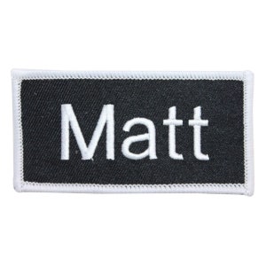 May include: White embroidered name tag with a black background. The name "Matt" is stitched in white on the tag.
