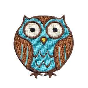 May include: Embroidered owl patch featuring a teal body, brown wings, and large white eyes with black pupils. The owl has a yellow beak and brown outline. This patch is suitable for jackets, bags, or other fabric items.