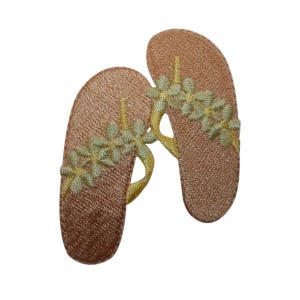May include: Two pink embroidered flip-flops with yellow flower designs.