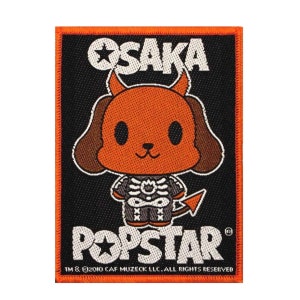 May include: A black and orange embroidered patch featuring a cartoon dog wearing a skeleton costume and devil horns. The text "OSAKA POPSTAR" is written in white on the patch.