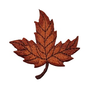 May include: A brown embroidered maple leaf with a detailed vein pattern. The leaf is a popular symbol of autumn and fall.