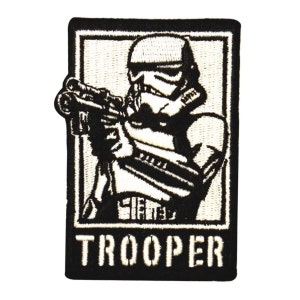 May include: Black and white embroidered patch of a Star Wars Stormtrooper holding a blaster rifle. The patch has a white border and the word "TROOPER" in white lettering at the bottom.