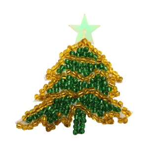 May include: A green and gold beaded Christmas tree ornament with a star on top.