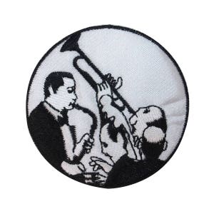 May include: Black and white embroidered patch depicting three musicians playing instruments. The musicians are silhouetted against a white background.