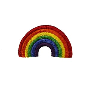 May include: An embroidered patch in the shape of a rainbow arc. The patch is made from red, orange, yellow, green, blue, indigo and violet thread.