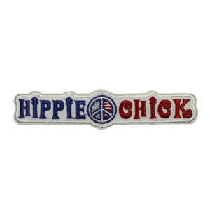 May include: White embroidered patch with the text "Hippie Chick" in blue and red lettering. A peace sign with an American flag design is in the center.
