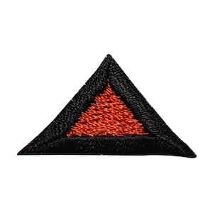 May include: A black triangle patch with a red triangle inside. The patch is made of fabric and has a stitched edge.