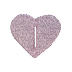 May include: A pink felt heart with a slit in the center. The heart is a craft supply for sewing or other crafts.