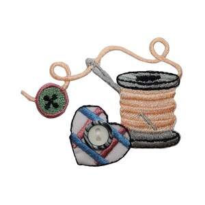 May include: An embroidered patch with a spool of thread, a heart-shaped button, and a button with a cross design. The thread is pink and the button is white with black trim.