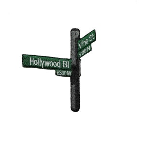 May include: Embroidered signpost featuring green signs with white text. The signpost reads "Hollywood BI 6300 W" and "Vine St 1700 N". The post is dark gray and the signs are green.