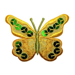 May include: A yellow butterfly with green sequins embroidered on its wings.