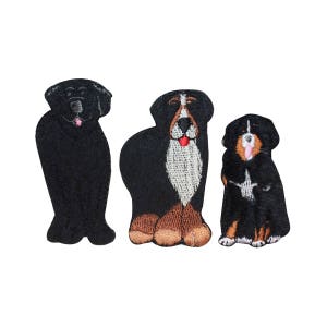 May include: Three embroidered dog patches. The first is a black dog with a pink tongue. The second is a black and brown dog with a white chest and a red tongue. The third is a black and brown dog with a white chest and a pink tongue.