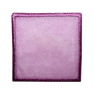 May include: A purple fabric patch with a satin-like finish and a dark purple stitched border.