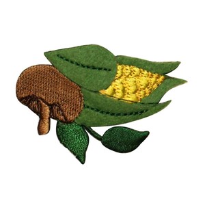 May include: An embroidered patch of a brown corn cob with green leaves. The corn cob is yellow and the leaves are green.