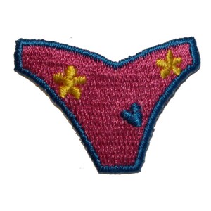 May include: Pink embroidered patch shaped like a pair of underwear with yellow flower designs and a blue heart.