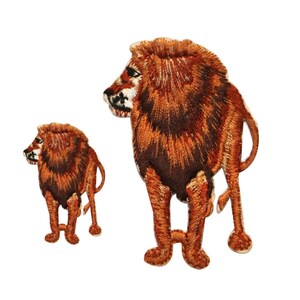 May include: Two embroidered iron-on patches of lions. The larger lion is brown and orange with a mane. The smaller lion is brown and orange. Both lions are facing to the right.