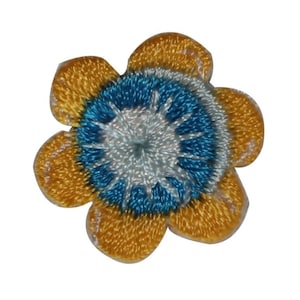 May include: A yellow flower with a blue and white center. The flower is embroidered and has a 3D effect.