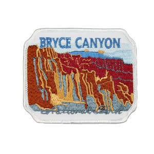May include: White embroidered patch with a colorful image of Bryce Canyon National Park and the text "Bryce Canyon National Park".