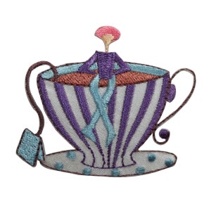 May include: Embroidered patch featuring a whimsical teacup design. The teacup is white with purple vertical stripes and a blue rim. A tea bag and handle are attached. The tea inside is brown and blue, and a figure is inside the cup.