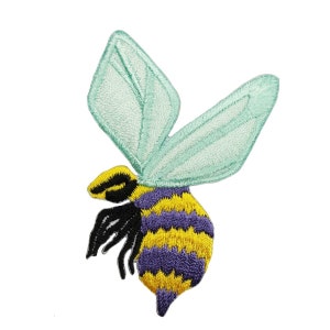 May include: An embroidered patch of a bee with yellow and purple stripes, black legs, and light blue wings.