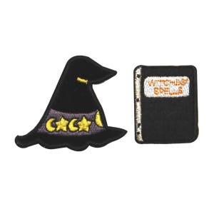 May include: Two embroidered patches: a black witch hat with gold stars and crescent moon, and a black book with the words "Witches Spells" in orange. The hat has a purple band. These patches are perfect for Halloween or witch-themed crafts.