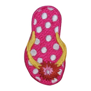 May include: Pink embroidered flip-flop with white polka dots and a yellow strap. The flip-flop has a red, pink, and white flower design.