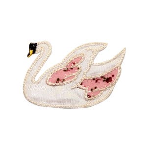 May include: A white swan applique with pink floral wings. The swan is embroidered with a black and yellow beak.