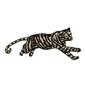 May include: Black and white embroidered iron-on patch of a stylized leaping tiger.