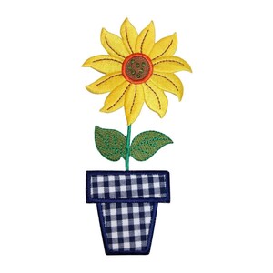 May include: A yellow sunflower with an orange centre is in a blue and white gingham pot.