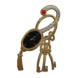 May include: Gold embroidered patch featuring a clock with a black face and gold hands, a gold tassel, and three gold keys. The clock is attached to a white rope with a red bead.