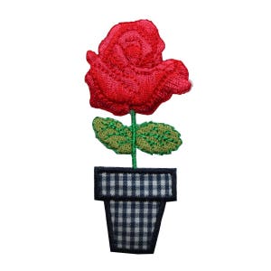 May include: Red embroidered rose with green leaves in a black and white gingham pot.