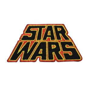 May include: Embroidered patch featuring the "STAR WARS" logo in black letters with a red outline and yellow border. The patch is rectangular with a unique shape, perfect for jackets, bags, or other fabric items. The design is a classic representation of the popular science fiction franchise.