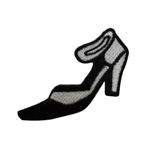 May include: Black high-heeled shoe with a silver strap and a pointed toe.