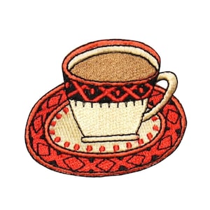 May include: An embroidered iron-on patch of a red and black teacup with a saucer. The teacup has a brown liquid inside and a red and black geometric pattern around the rim.
