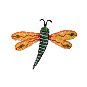 May include: A colorful embroidered dragonfly patch with orange, yellow, green, and black accents. The dragonfly has a long, slender body and delicate wings.