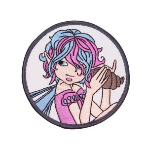 May include: A round embroidered patch featuring a fairy with pink and blue hair holding a seashell to her ear. The fairy is wearing a pink dress with white trim and has a blue and white fairy wing.