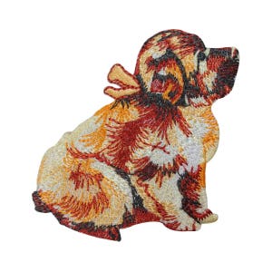 May include: Embroidered iron-on patch of a brown and orange dog with a white background.
