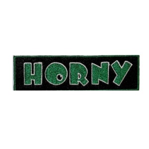 May include: A black and green embroidered patch with the word "HORNY" in large, bold letters.